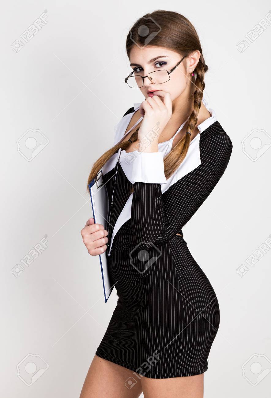 Sexy Secretary Portrait Of Beautiful Brunette Business Lady With Glasses And Wearing In Pinstripe Suit Sexy Secretary Portrait Of Beautiful Brunette Business Lady With Glasses And Wearing In Pinstripe Suit
