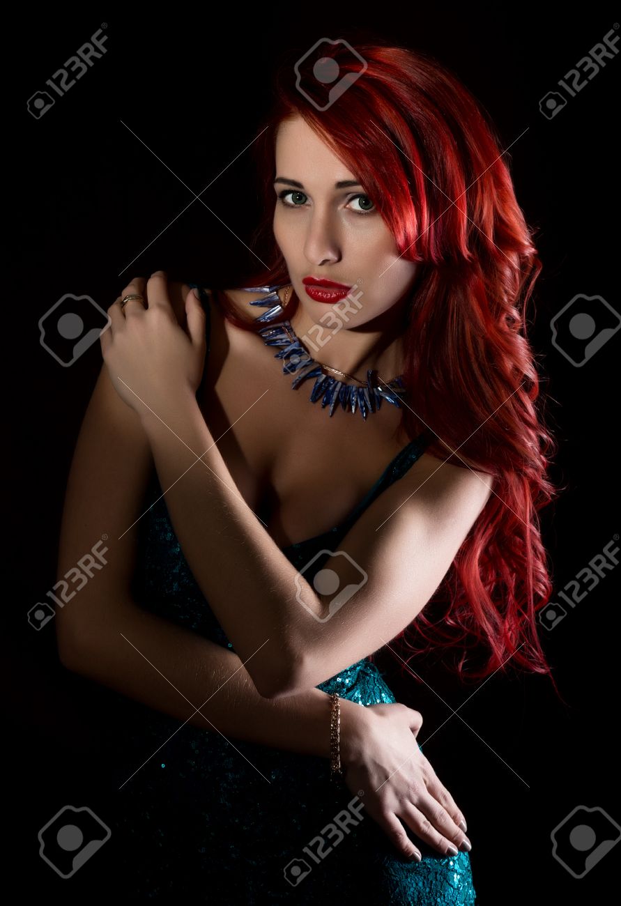 Beautiful Redhead Woman With Big Tits In A Tight Dress Posing On A Dark  Background. Stock Photo, Picture and Royalty Free Image. Image 75013779.