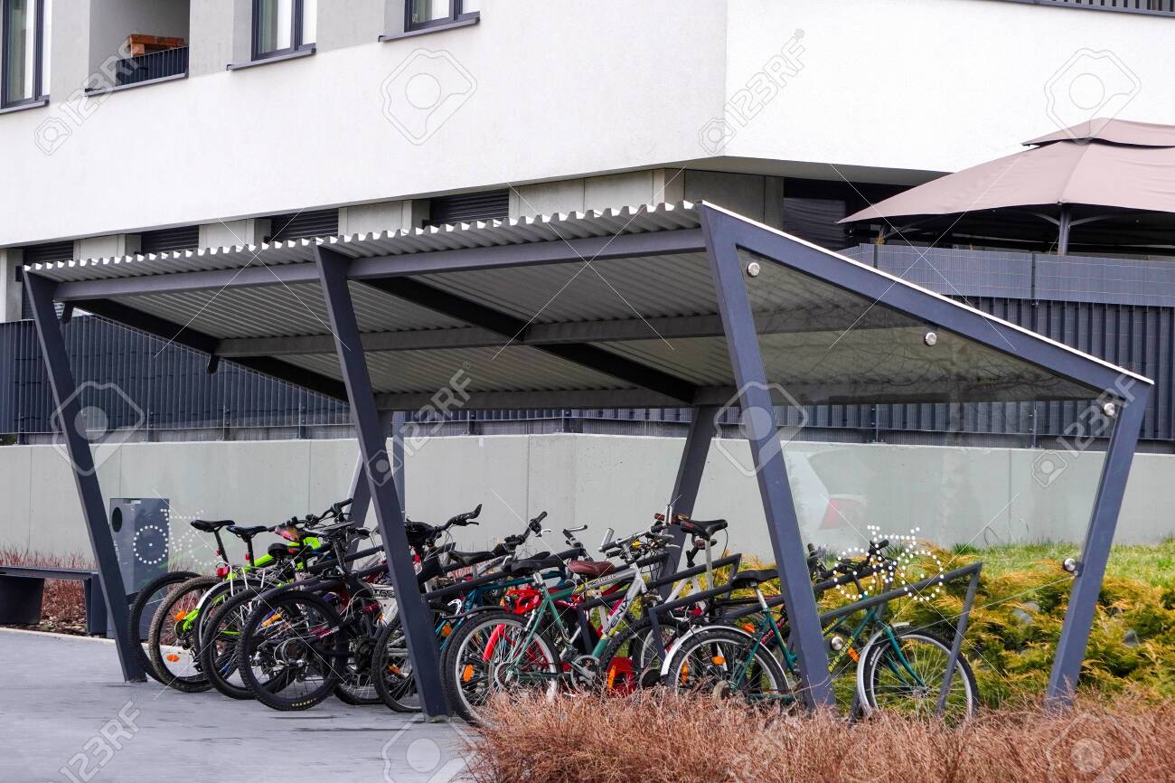 Modern Parking lot with a Bicycle roof near an apartment building with large number of bicycles. Eco-friendly and sports transport in the city. - 141709082 Modern Parking lot with a Bicycle roof near an apartment building with large number of bicycles. Eco-friendly and sports transport in the city. - 141709082