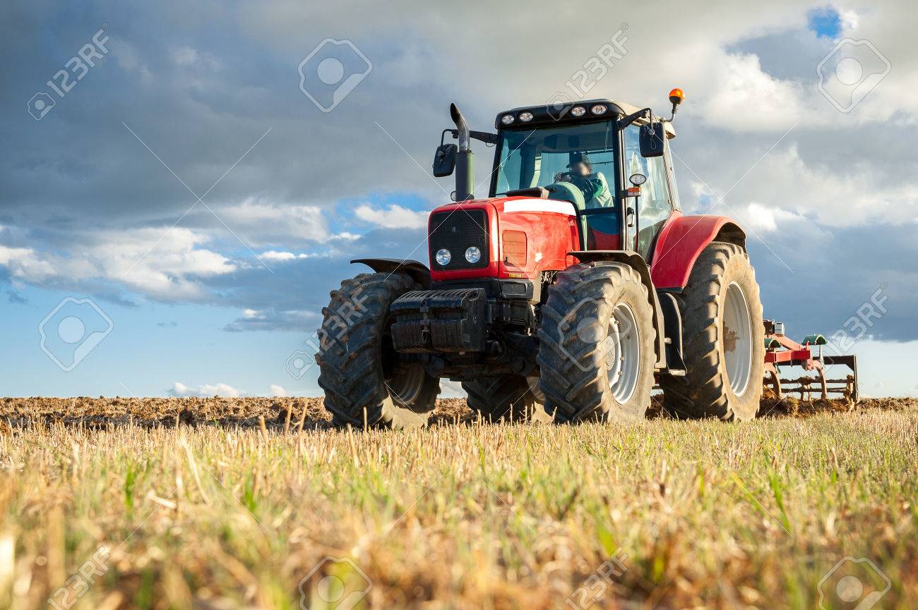 agricultural machinery in the foreground carrying out work in the field - 82343940 agricultural machinery in the foreground carrying out work in the field - 82343940
