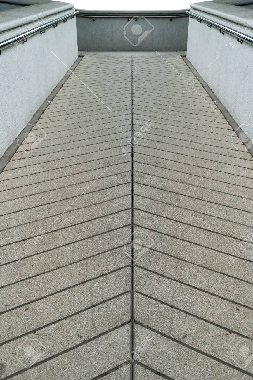 concrete ramp for wheelchair with stainless railing stock photo