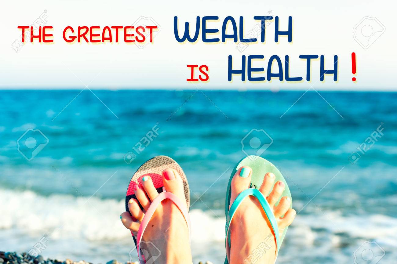 The Greatest Wealth Is Health. Motivational Inspirational Quote With Funny  Cute Tidy Woman's Feet On The Beach On Ocean Waves Background. Colored  Horizontal Summertime Image With Vintage Filter. Stock Photo, Picture and, image size:1300x865