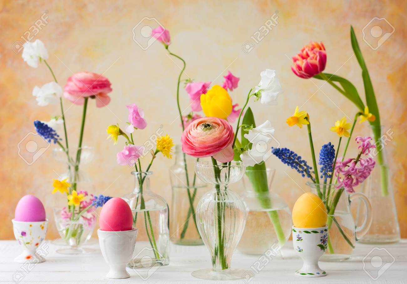 Beautiful Flowers Bouquets In Glass Vases On Festive Easter Table