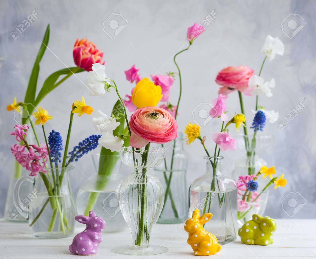 Beautiful Flowers Bouquets In Glass Vases On Festive Easter Table