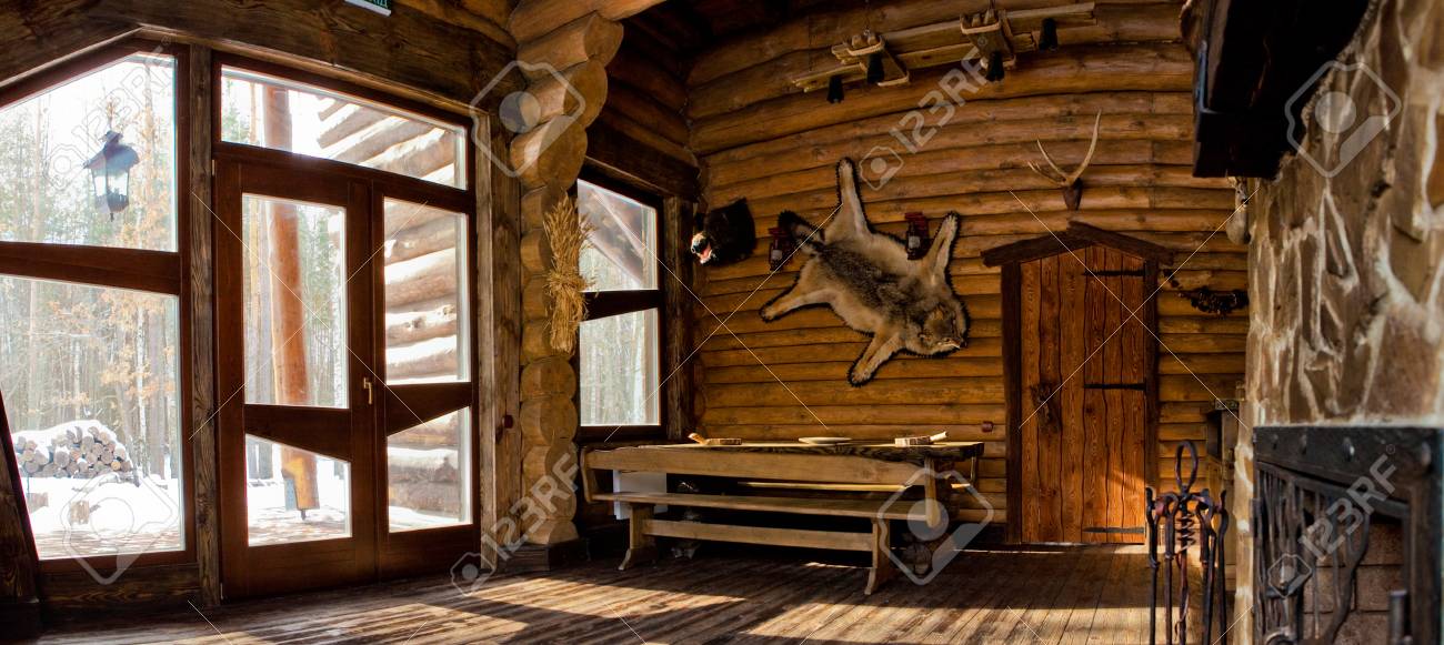 Country Style Interior In Hunter Chalet With Fireplace Stock Photo