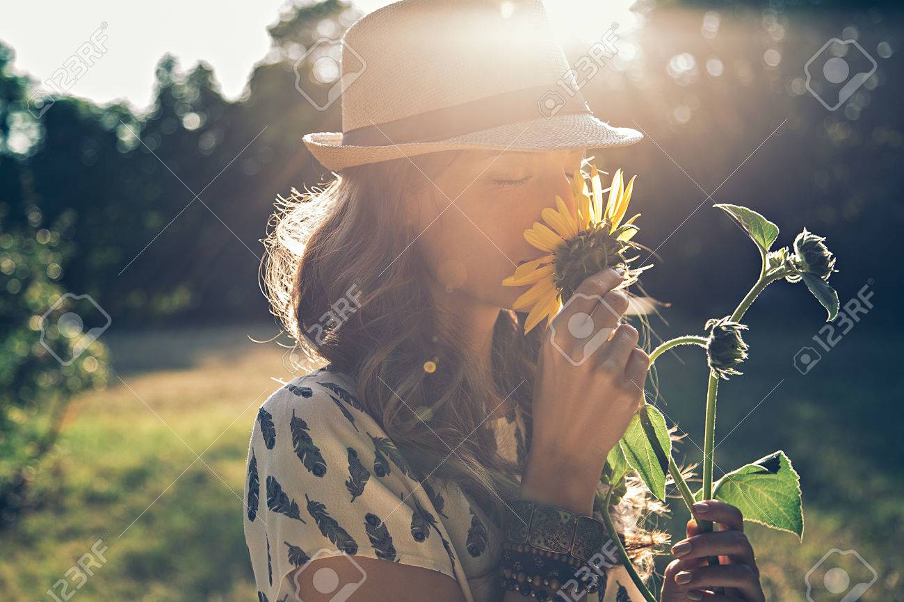 Girl smells sunflower in nature - 54033908 Girl smells sunflower in nature - 54033908