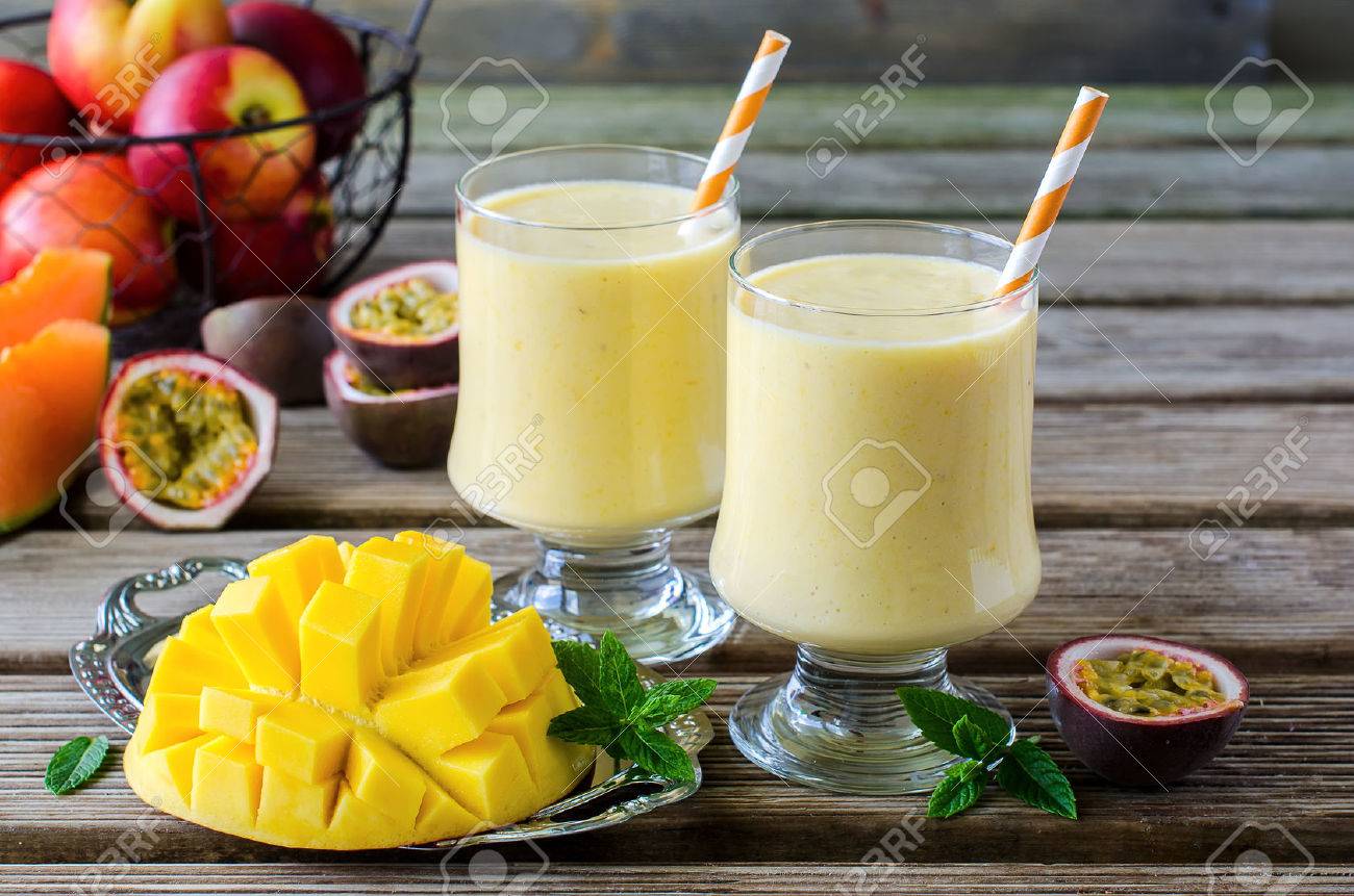 Healthy vitamin tropical mango and passion fruit smoothie with yogurt milkshake two glasses on wooden background - 41905832 Healthy vitamin tropical mango and passion fruit smoothie with yogurt milkshake two glasses on wooden background - 41905832