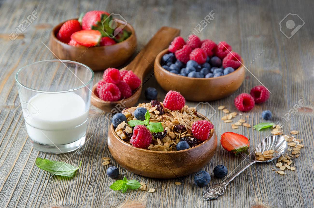 Breakfast with rolled oats and berries in wooden bowls - 54942646 Breakfast with rolled oats and berries in wooden bowls - 54942646