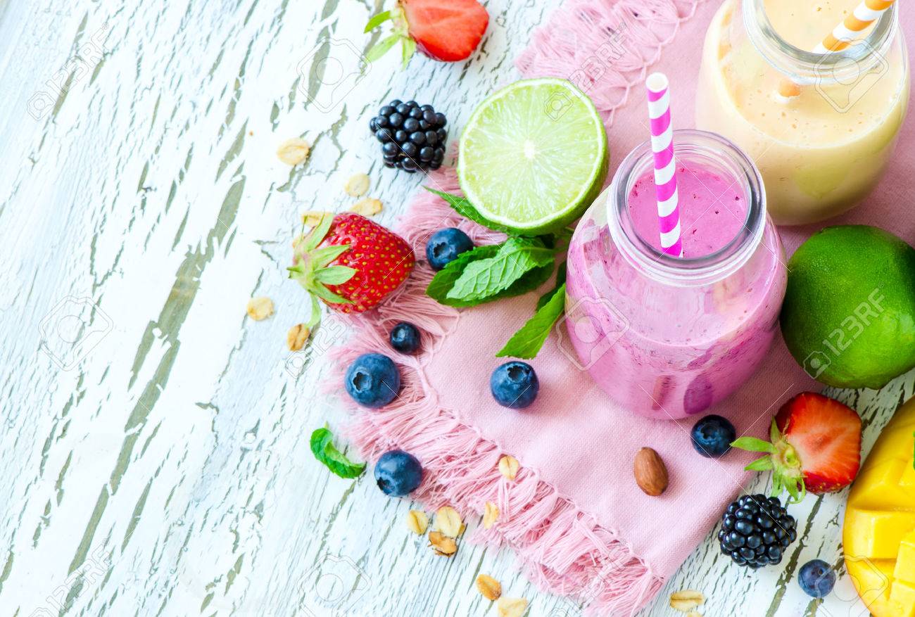 Berry and fruit smoothie in bottles, healthy summer detox yogurt drink, diet or vegan food concept, fresh vitamins, mango, lime - 60638838 Berry and fruit smoothie in bottles, healthy summer detox yogurt drink, diet or vegan food concept, fresh vitamins, mango, lime - 60638838
