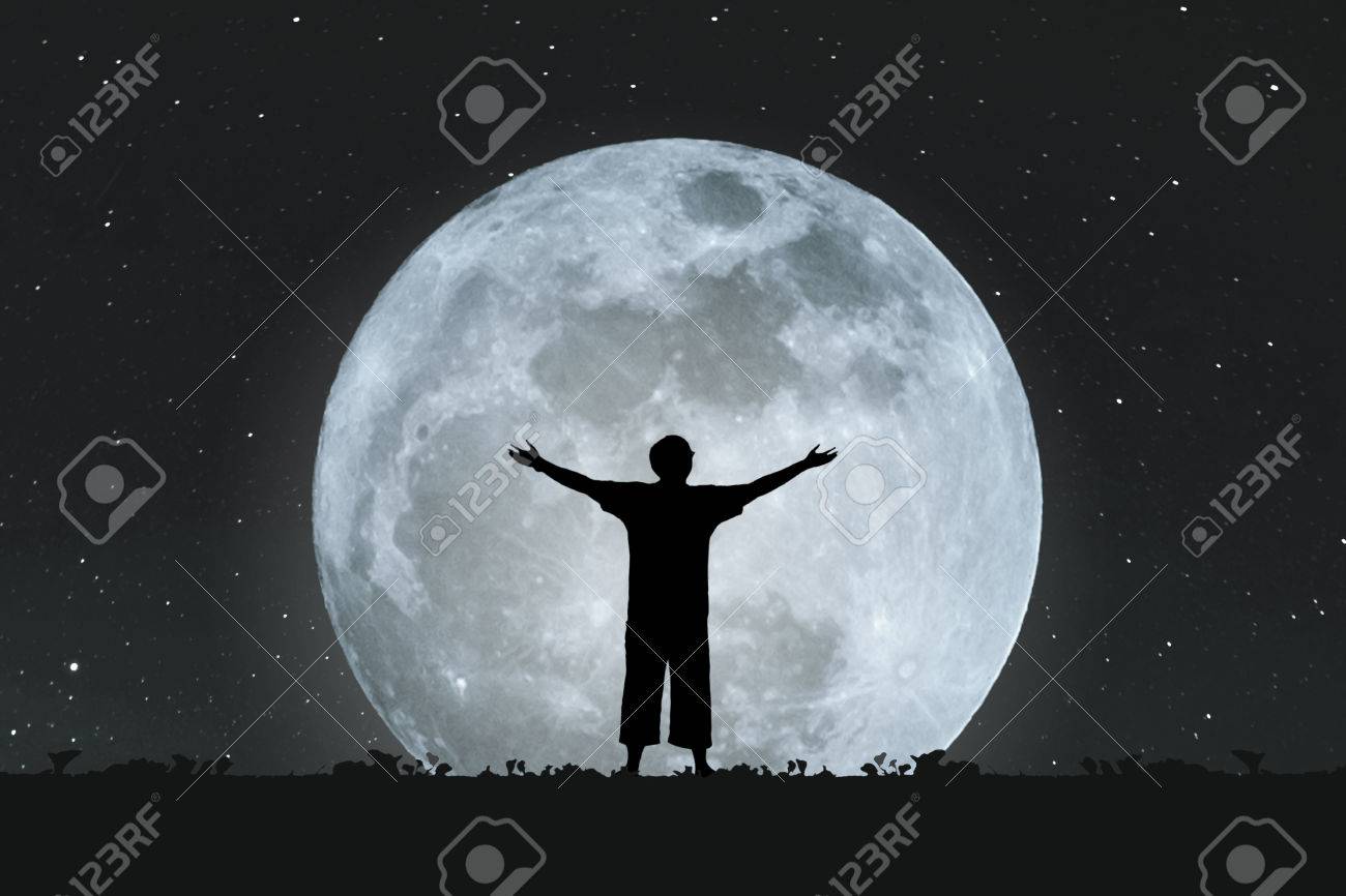 Silhouette A Man Stretching Hands Under Full Moon At Night With Stock Photo Picture And Royalty Free Image Image 68432722