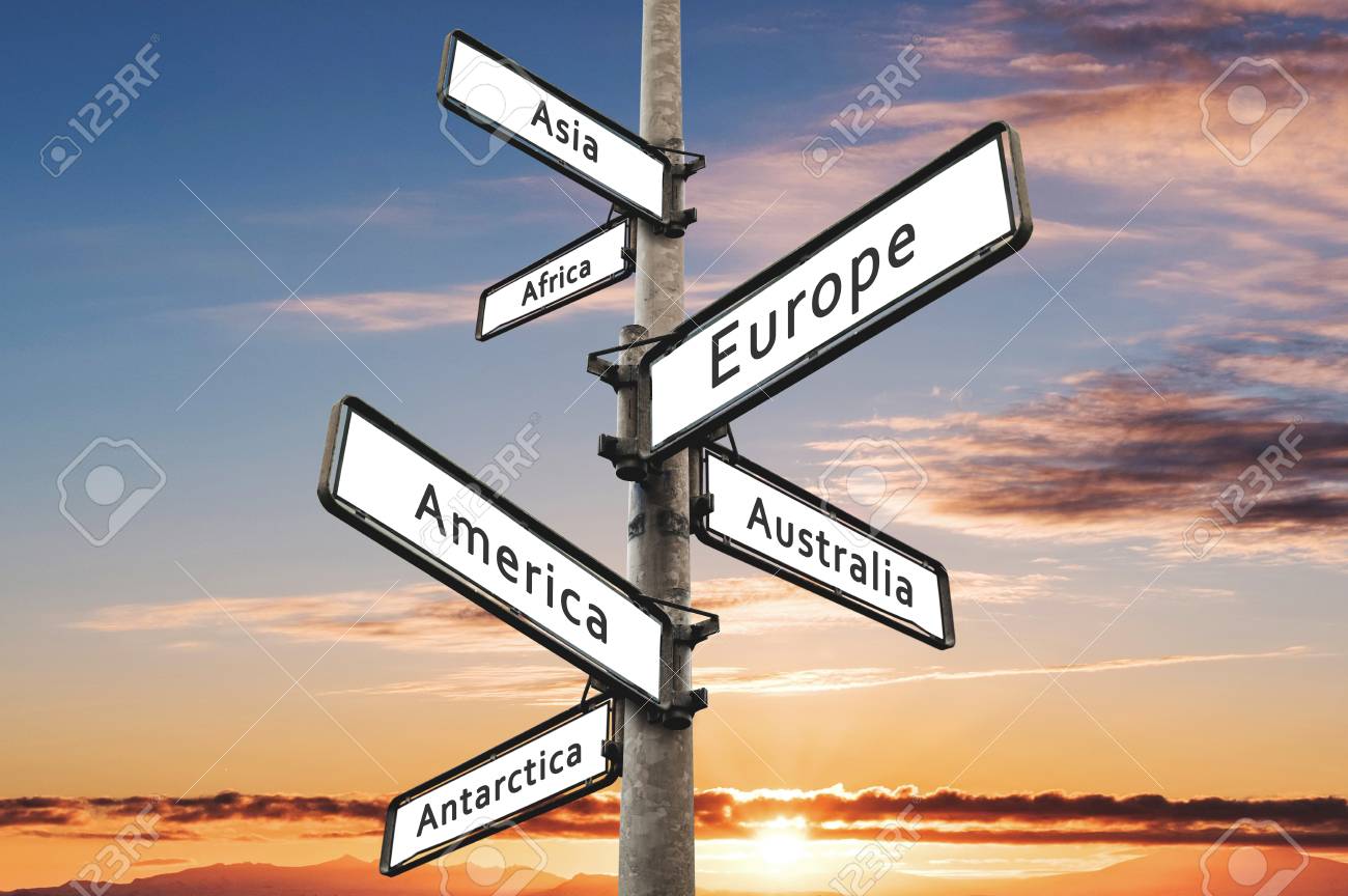 continents on road direction signpost with sunset sky background