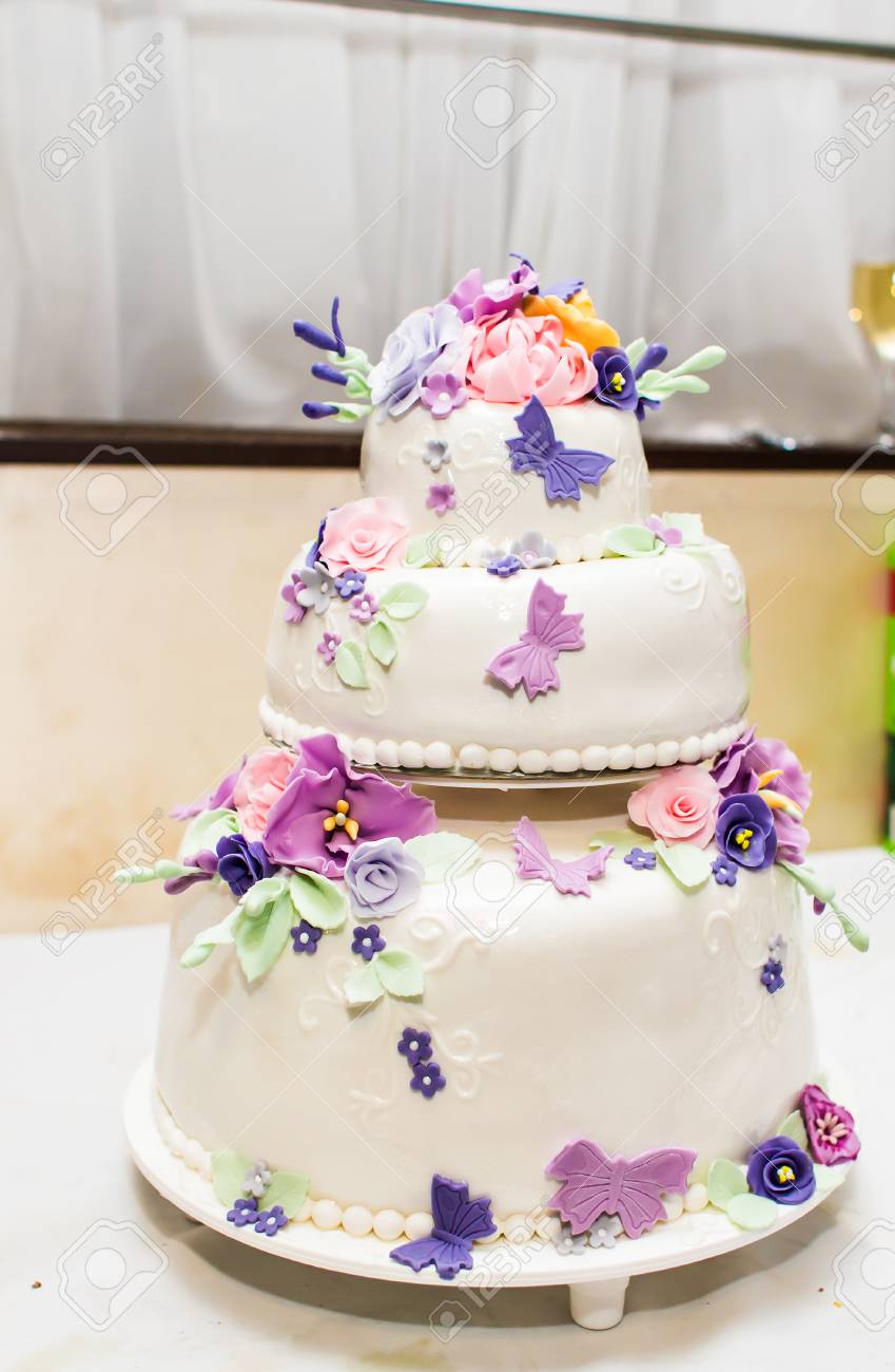 White Wedding Cake With Sugar Butterflies And Flowers Stock Photo