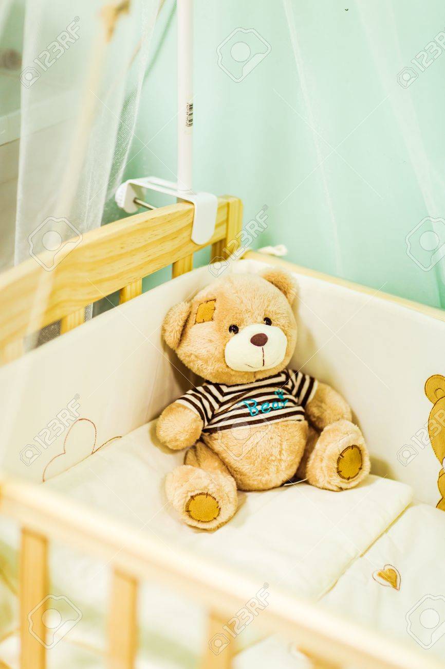 teddy bear in crib