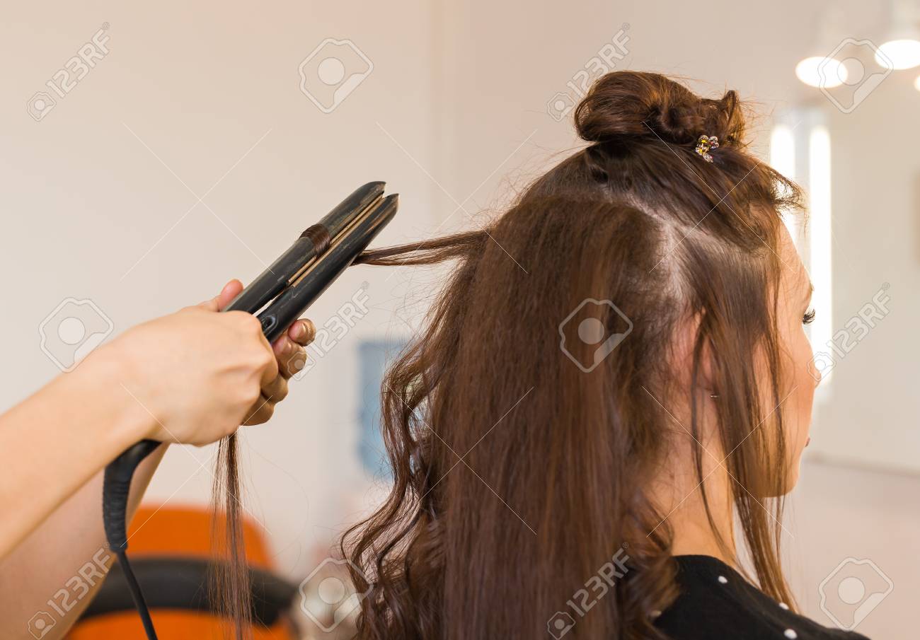 Curling Hair In Beauty Salon Professional Hairdresser Styling