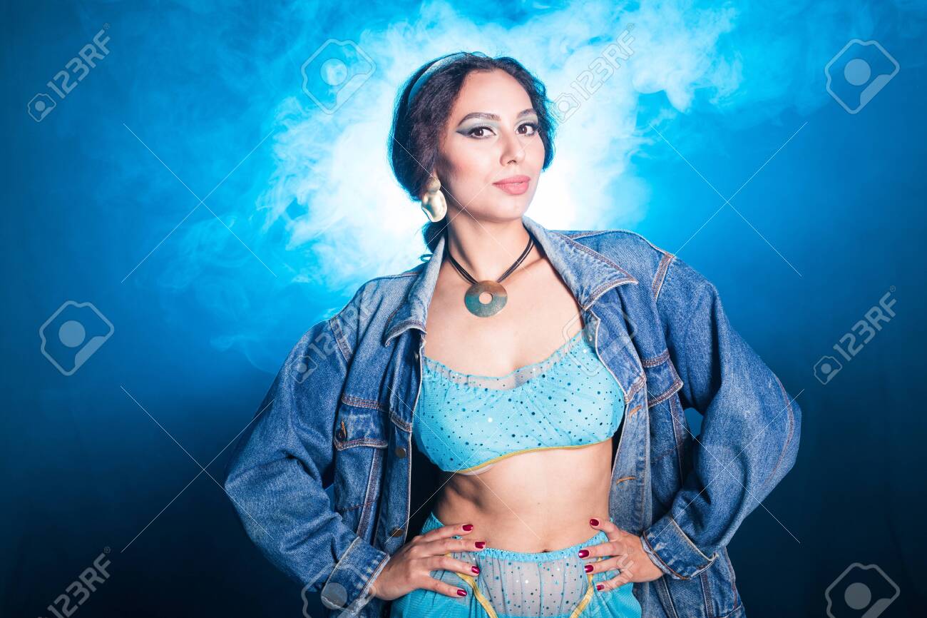 Magic, cosplay and fairy tale concept - Portrait of a young woman in the image of an Eastern fairy Princess on blue background. - 144776175 Magic, cosplay and fairy tale concept - Portrait of a young woman in the image of an Eastern fairy Princess on blue background. - 144776175