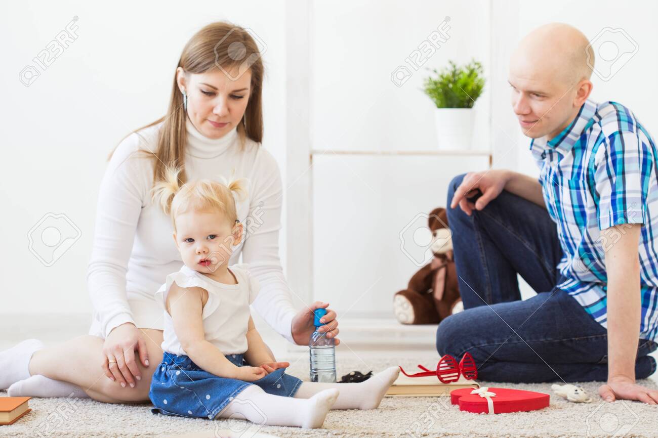 Hearing aid in baby girls ear. Toddler child wearing a hearing aid at home. Disabled child, disability and deafness concept. - 146680500 Hearing aid in baby girls ear. Toddler child wearing a hearing aid at home. Disabled child, disability and deafness concept. - 146680500