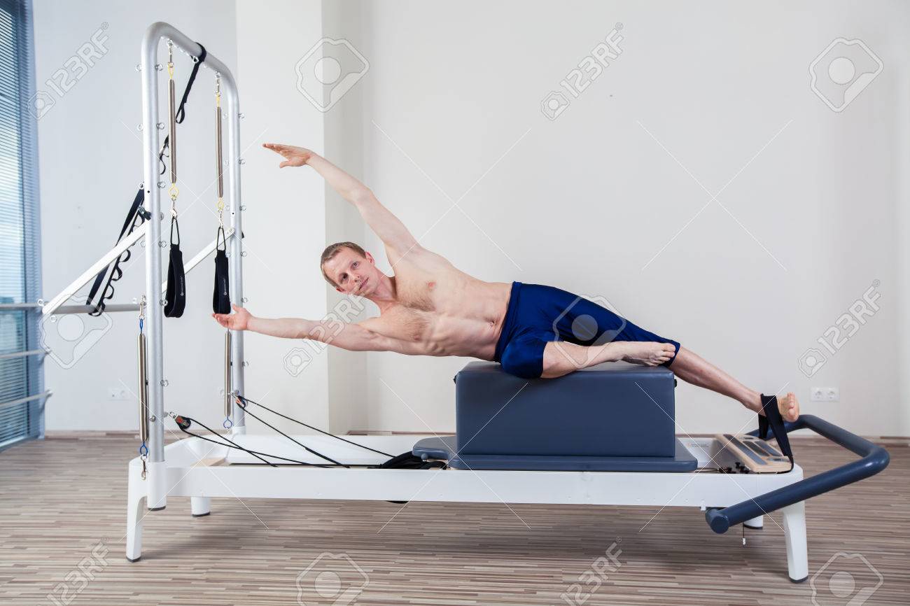 Pilates reformer workout exercises man at gym indoor - 40299522 Pilates reformer workout exercises man at gym indoor - 40299522