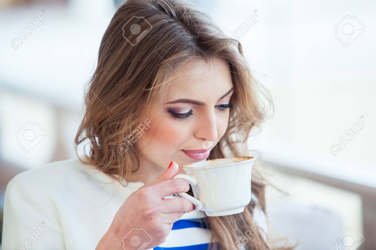beautiful young girl in outdoor cafe reading a book and drinking coffee. phone. student. business woman - 40614774 beautiful young girl in outdoor cafe reading a book and drinking coffee. phone. student. business woman - 40614774