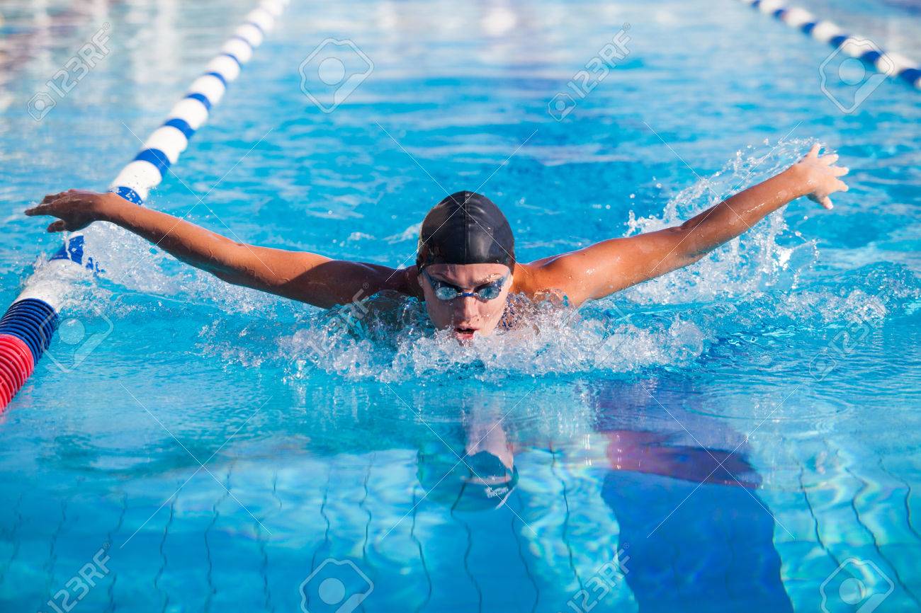 Butterfly swimmer in cap and glasses in the pool - 40854880 Butterfly swimmer in cap and glasses in the pool - 40854880
