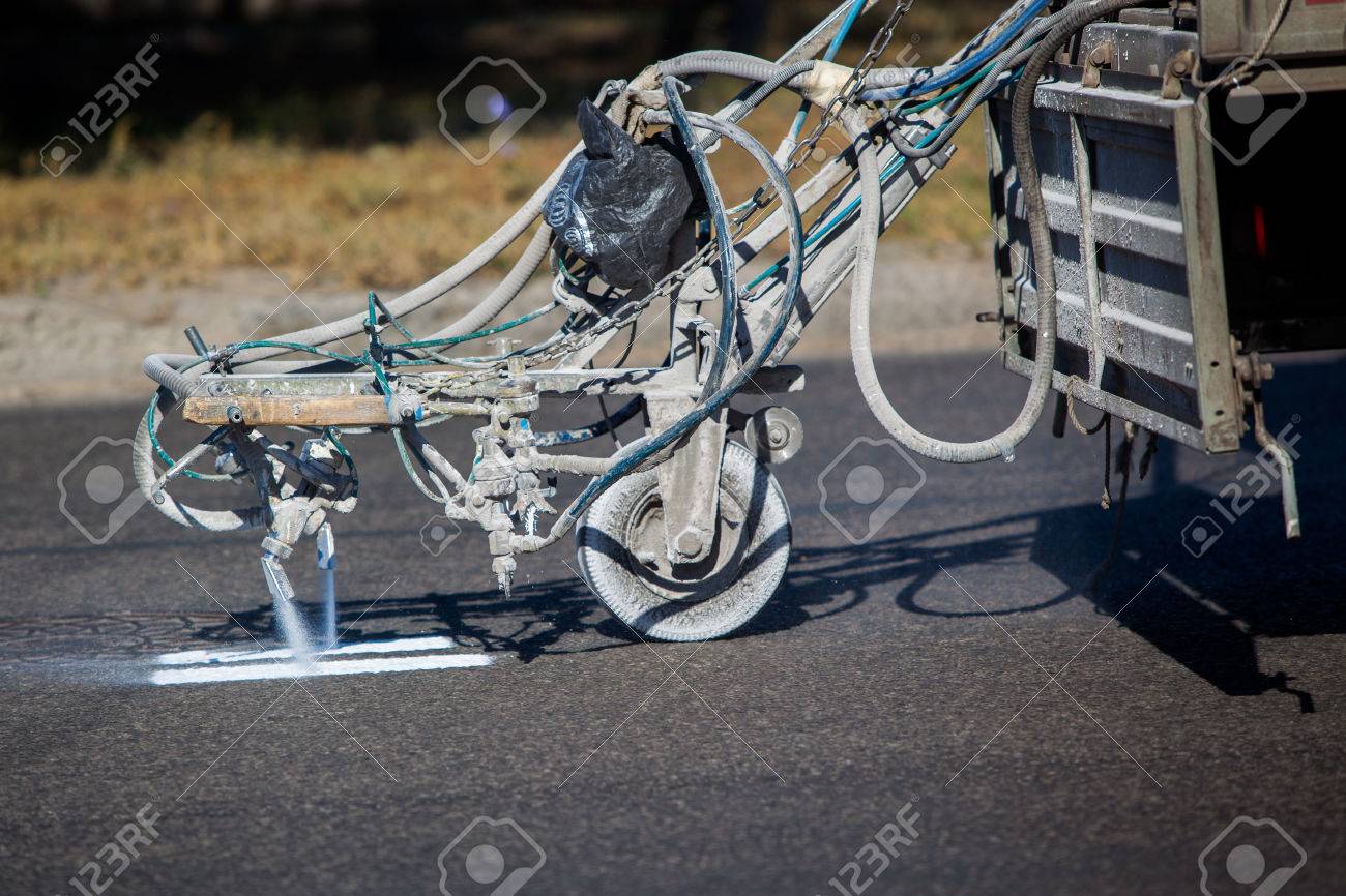 Teamwork: Pavement Asphalt Road Marking Paint and Striping with Thermoplastic Spray Applicator Machine during highway construction works. - 44463484 Teamwork: Pavement Asphalt Road Marking Paint and Striping with Thermoplastic Spray Applicator Machine during highway construction works. - 44463484