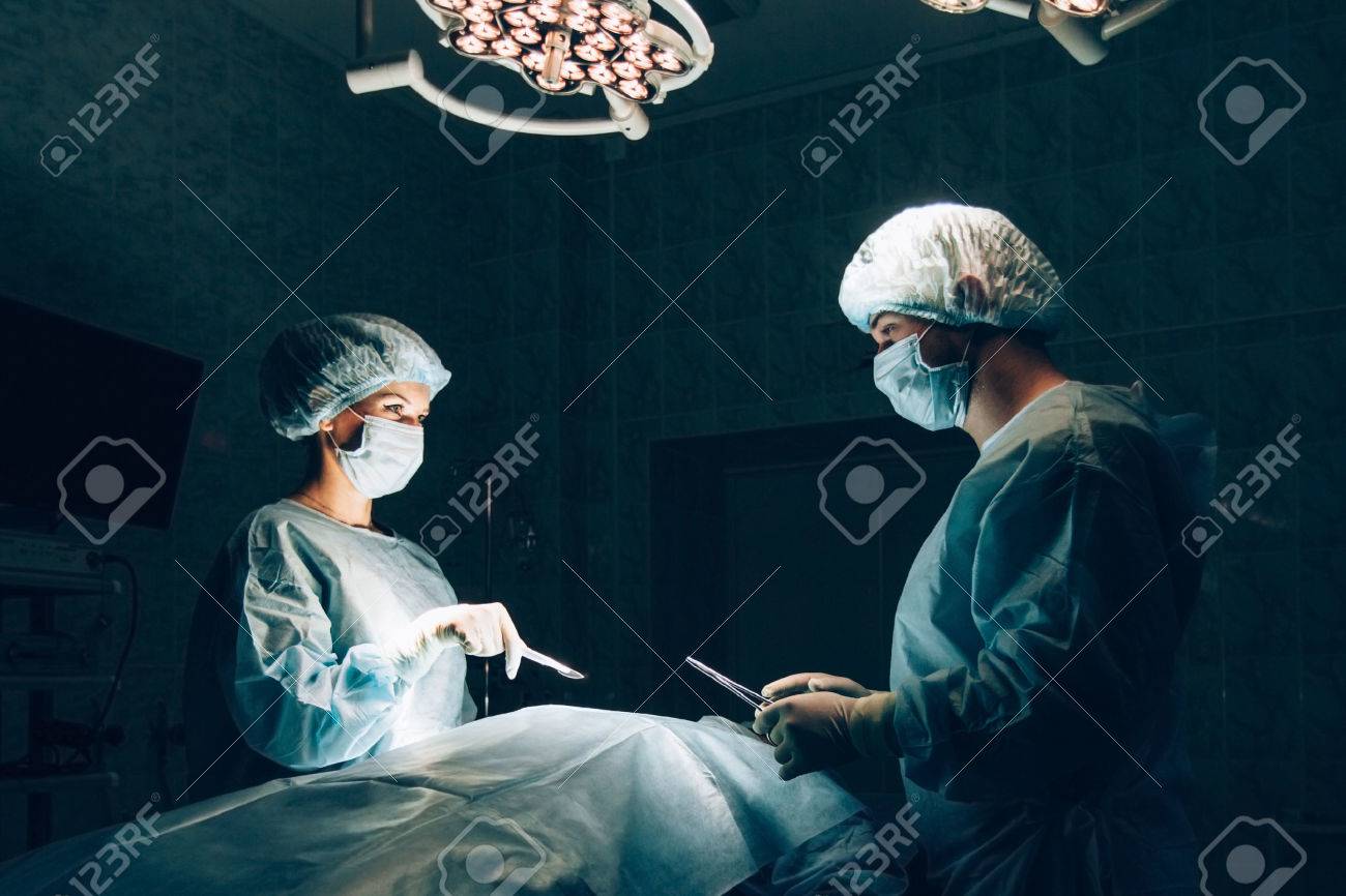 Surgeons team working with Monitoring of patient in surgical operating room - 46517204 Surgeons team working with Monitoring of patient in surgical operating room - 46517204