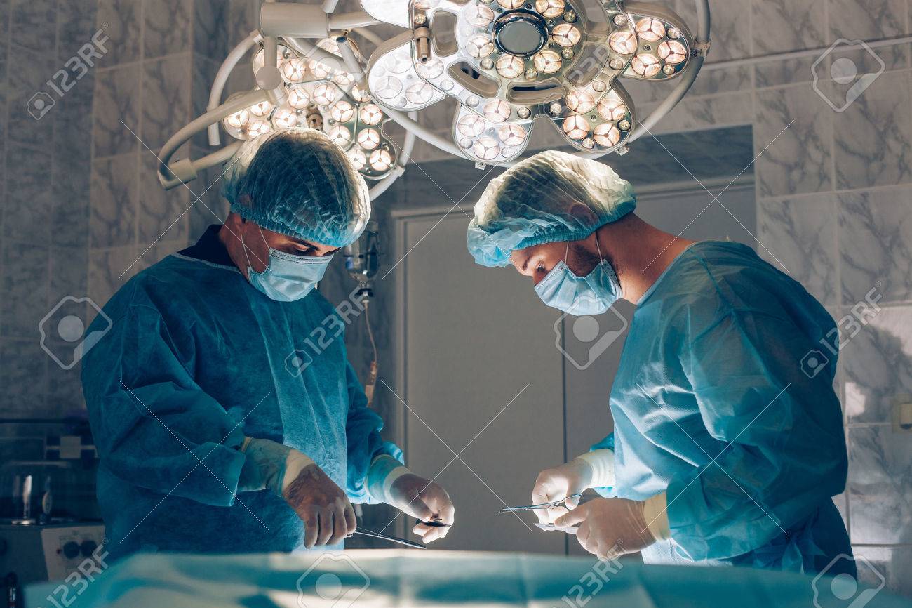 Surgeons team working with Monitoring of patient in surgical operating room - 46517073 Surgeons team working with Monitoring of patient in surgical operating room - 46517073
