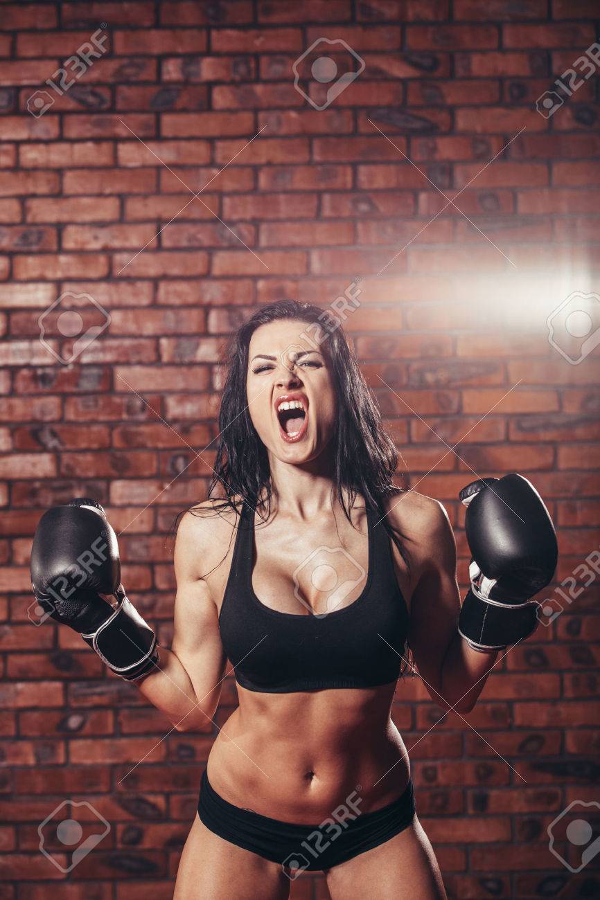 Young girl with boxing gloves, on the background wall of red brick - 47221564 Young girl with boxing gloves, on the background wall of red brick - 47221564