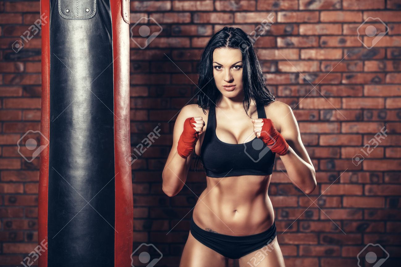 Young beautiful boxer woman with red boxing bandage on hands. - 47221322 Young beautiful boxer woman with red boxing bandage on hands. - 47221322