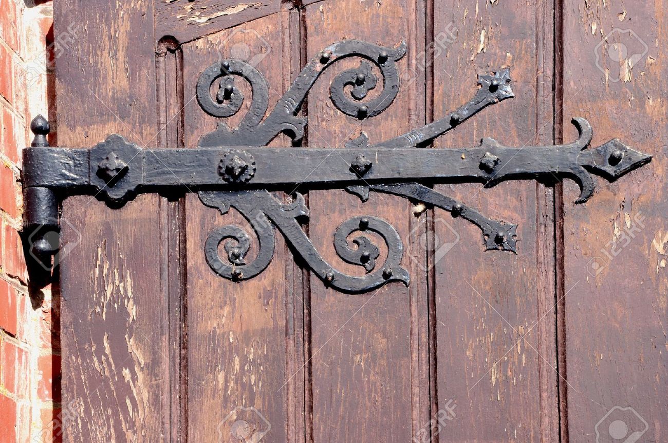detail of old decorative hinges holding wooden door architectural backdrop fragment stock photo - Decorative Hinges detail of old decorative hinges holding wooden door architectural backdrop fragment stock photo - Decorative Hinges