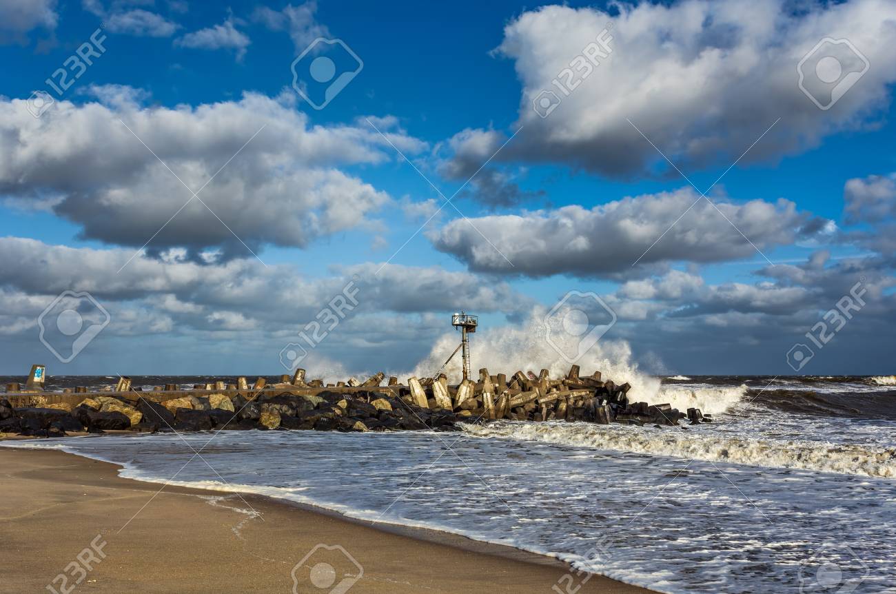 a wave crashing on a jetty in point pleasant nj at manasquan