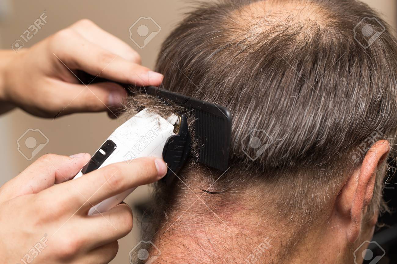 Close Up Of A Male Student Having A Haircut With Hair Clippers
