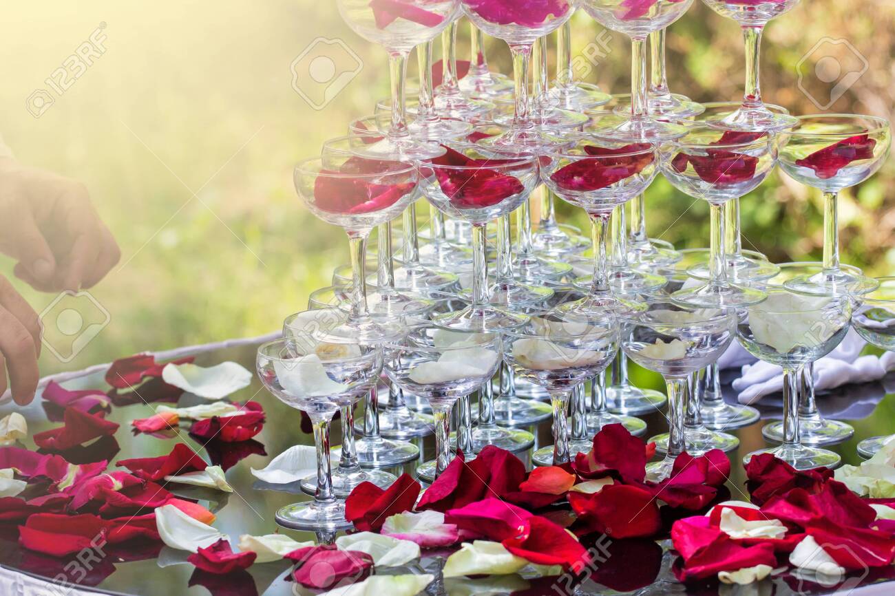 Pyramid With Wine Glasses On A Table Decorated With Rose Petals