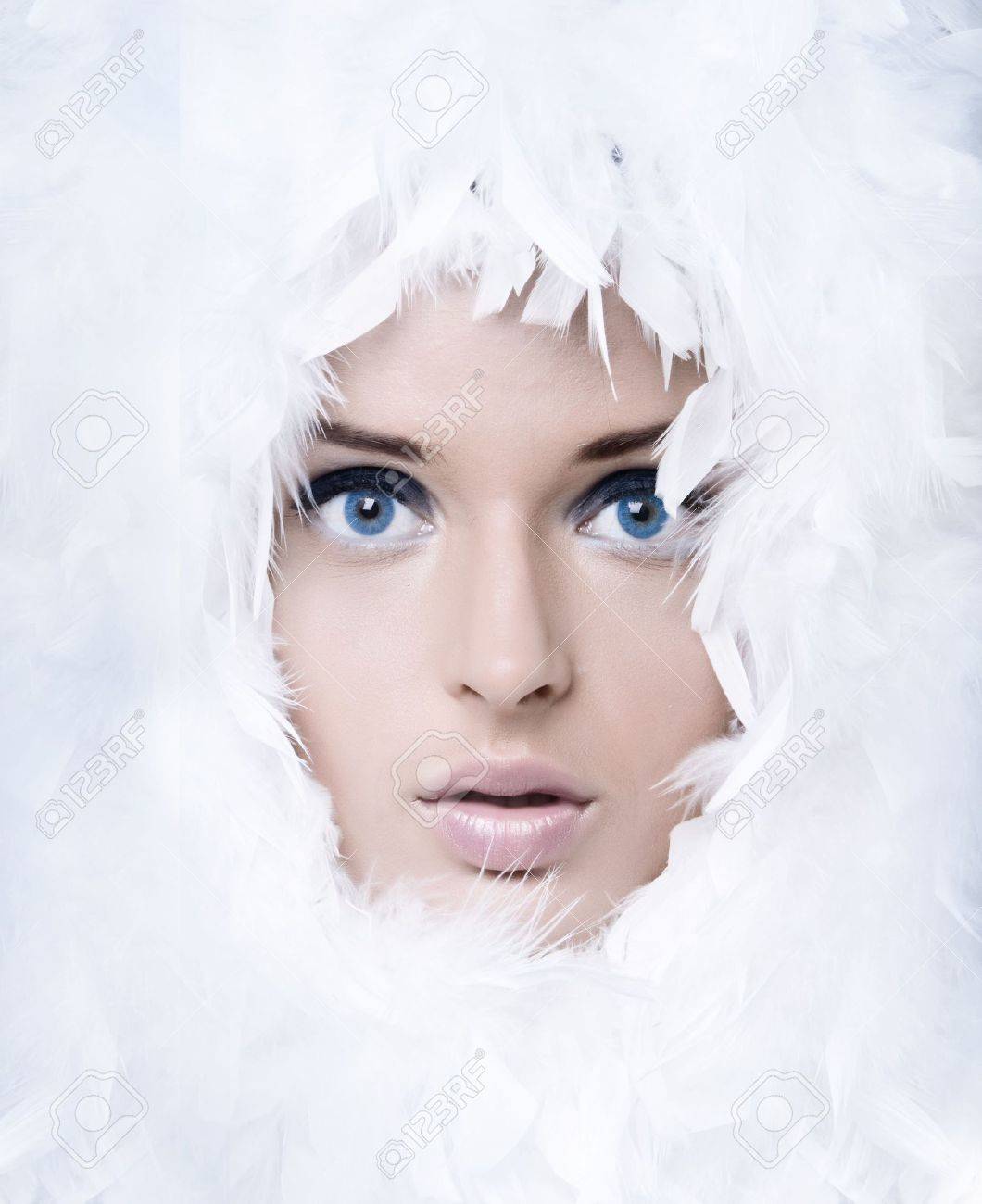 Closeup portrait of beautiful girl witk white feathers - 7873237 Closeup portrait of beautiful girl witk white feathers - 7873237