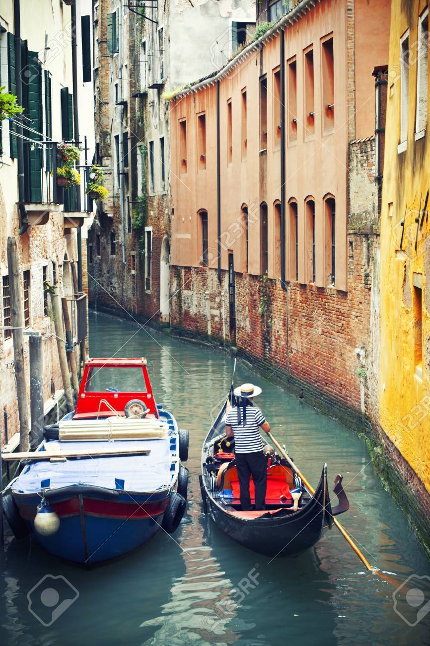 Gondolier in venetian canal, Venice, Italy - 36245698 Gondolier in venetian canal, Venice, Italy - 36245698