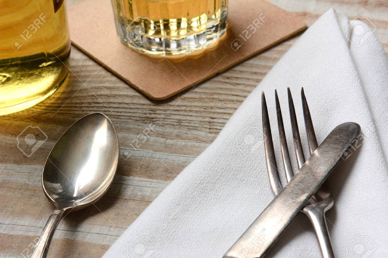 Closeup Of A Table Setting. Old Silverware, Napkin And Drinks ... Closeup Of A Table Setting. Old Silverware, Napkin And Drinks ...