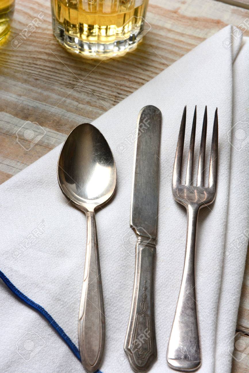 Closeup Of A Table Setting. Old Mismatched Silverware, Napkin ... Closeup Of A Table Setting. Old Mismatched Silverware, Napkin ...