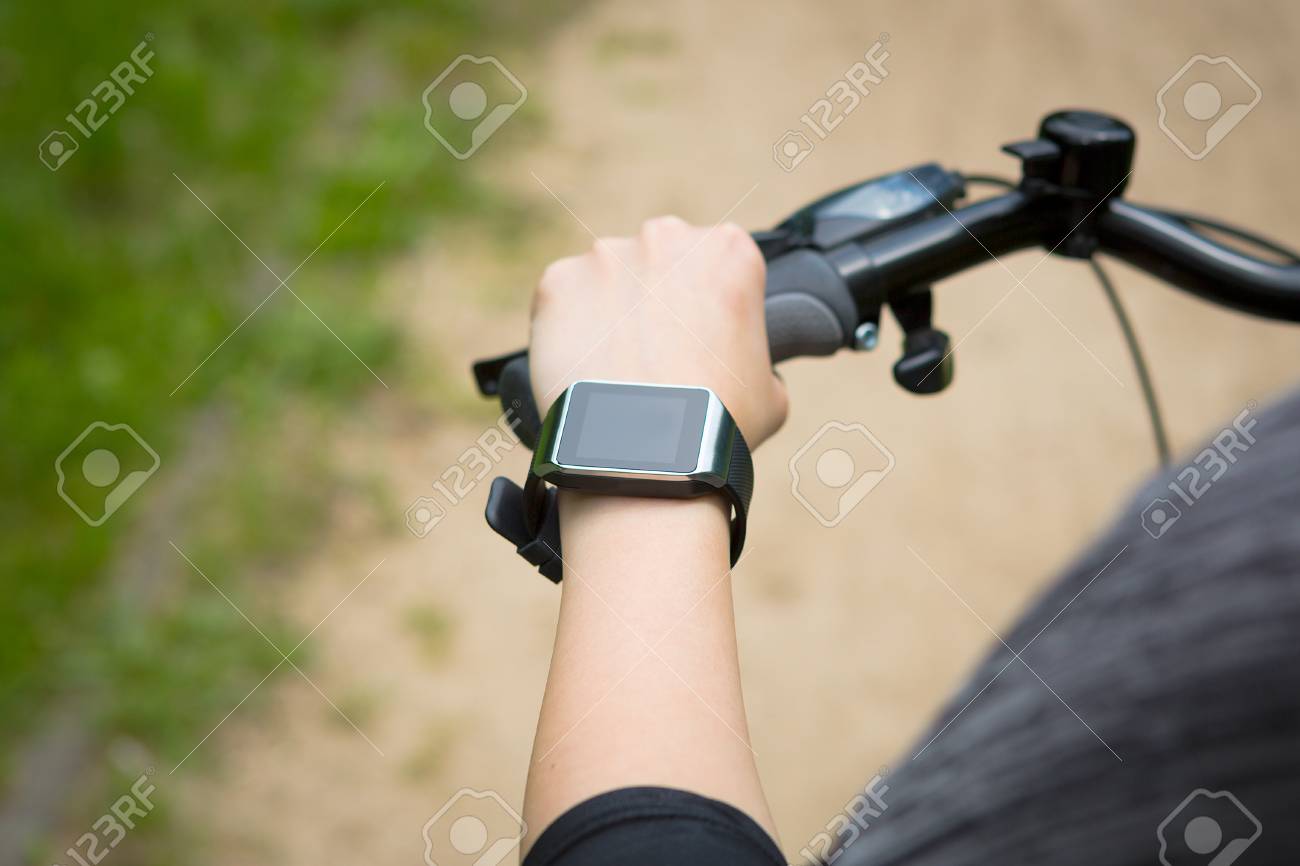 belegd broodje loyaliteit schattig Woman Riding A Bike With A SmartWatch Heart Rate Monitor. Smart Watch  Concept. Stock Photo, Picture And Royalty Free Image. Image 43398555.