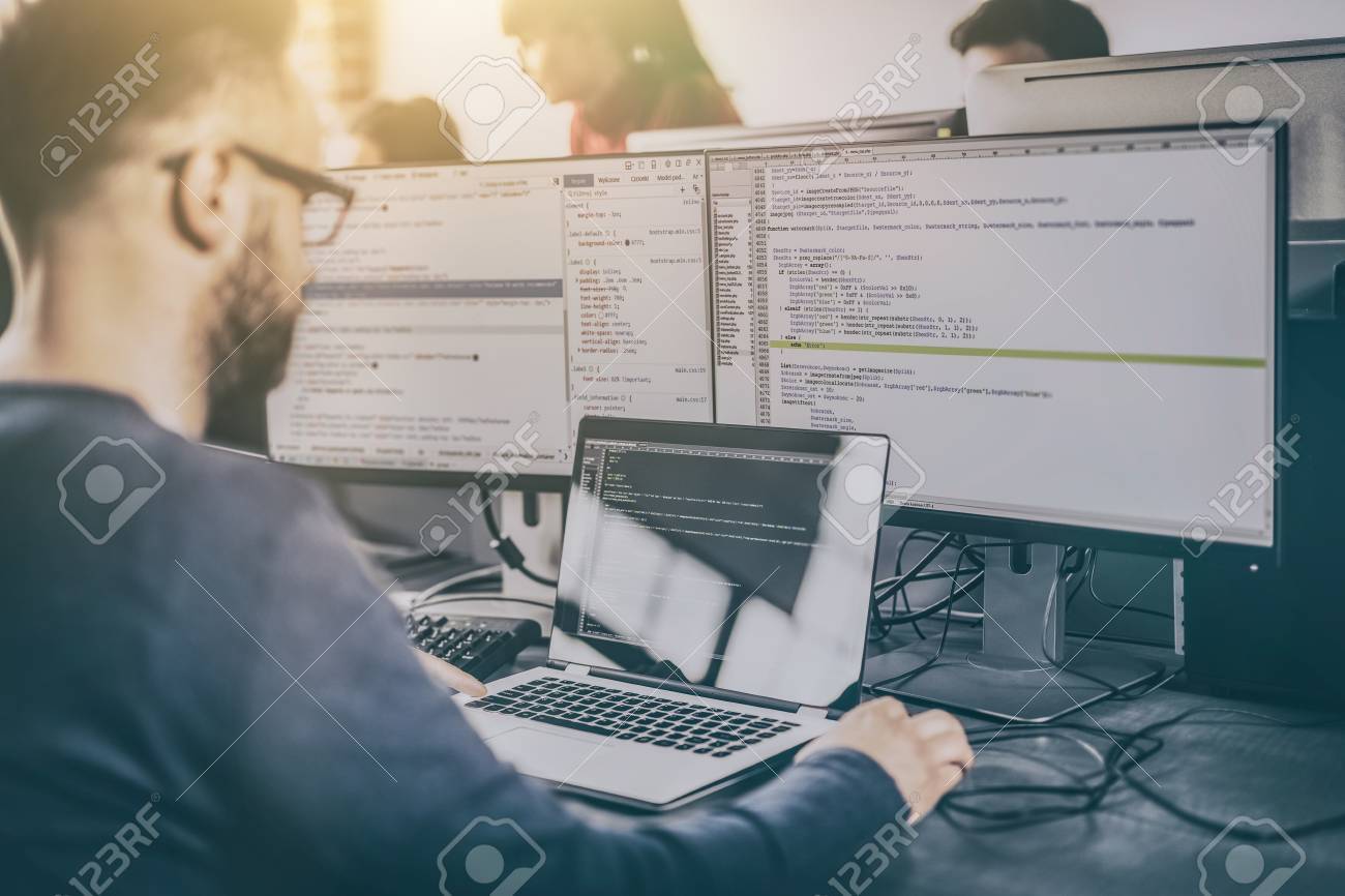 Developing programming and coding technologies. Website design. Programmer working in a software develop company office. - 84412931 Developing programming and coding technologies. Website design. Programmer working in a software develop company office. - 84412931