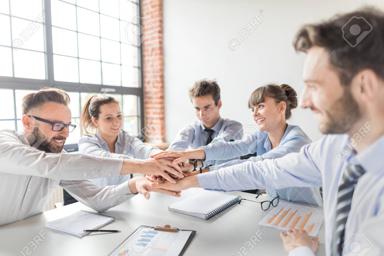 Close up top view of young business people putting their hands together. Stack of hands. Unity and teamwork concept. - 89225188 Close up top view of young business people putting their hands together. Stack of hands. Unity and teamwork concept. - 89225188