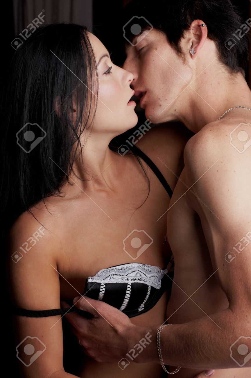 Stock Photo Young Adult Caucasian Couple In Passionate Embrace And Undressing Each Other During Sexual Foreplay Stock Photo Young Adult Caucasian Couple In Passionate Embrace And Undressing Each Other During Sexual Foreplay