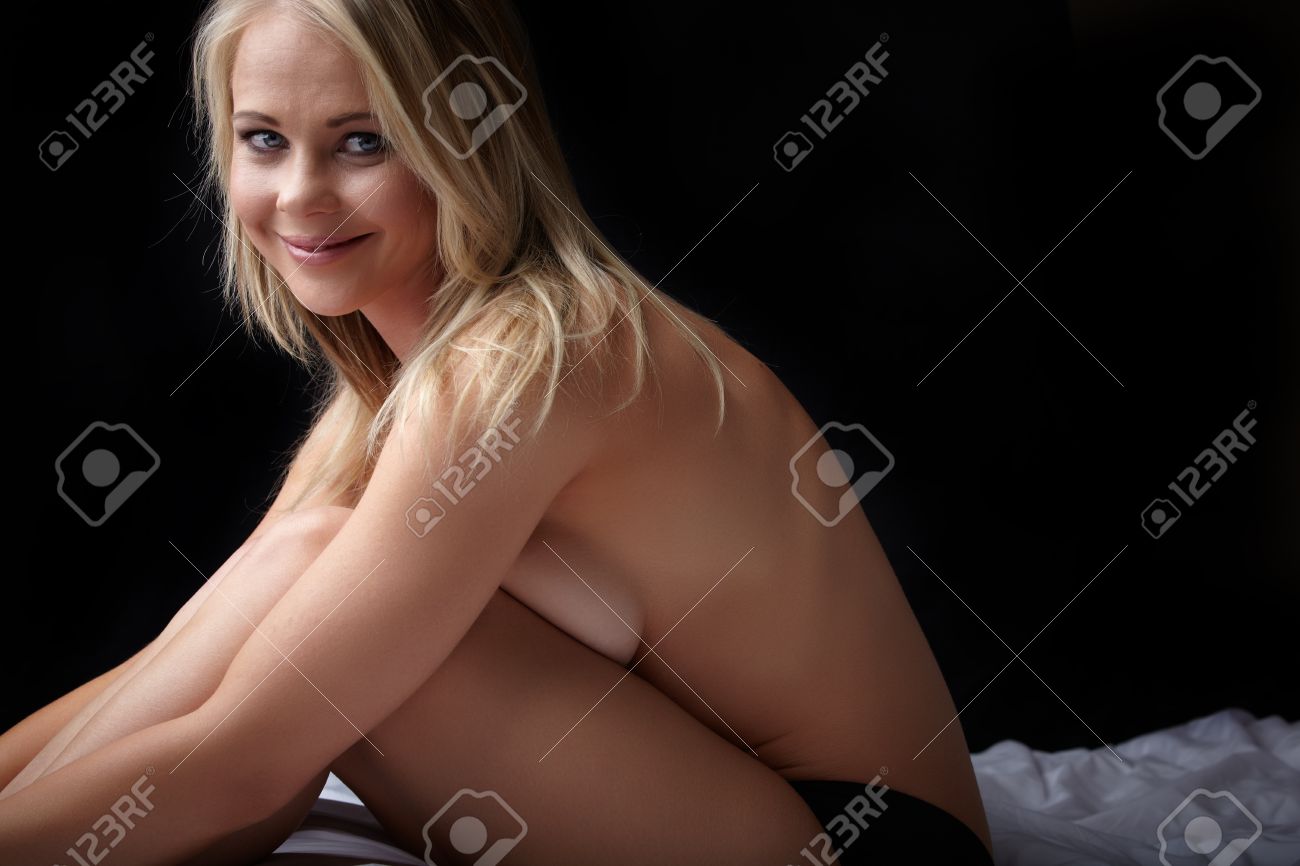 Nude Young Adult Caucasian Woman With Blonde Hair And Blue Eyes On A Dark  Background Stock Photo, Picture and Royalty Free Image. Image 11705937.