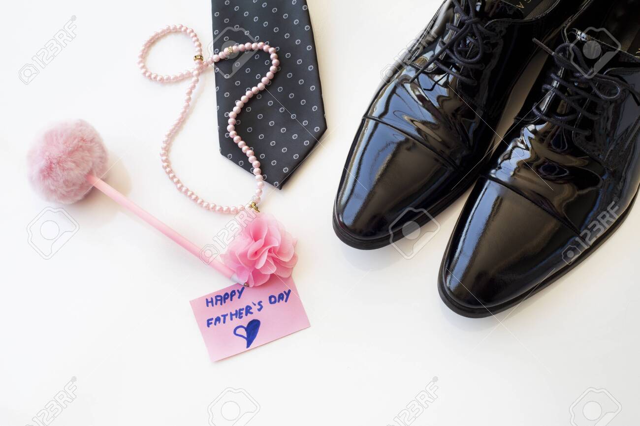 Father's Day Concept. Black Patent Leather Shoes, Tie and pearl necklace with greeting card on a white background. Copy space for text. Father's daughter. - 149178474 Father's Day Concept. Black Patent Leather Shoes, Tie and pearl necklace with greeting card on a white background. Copy space for text. Father's daughter. - 149178474