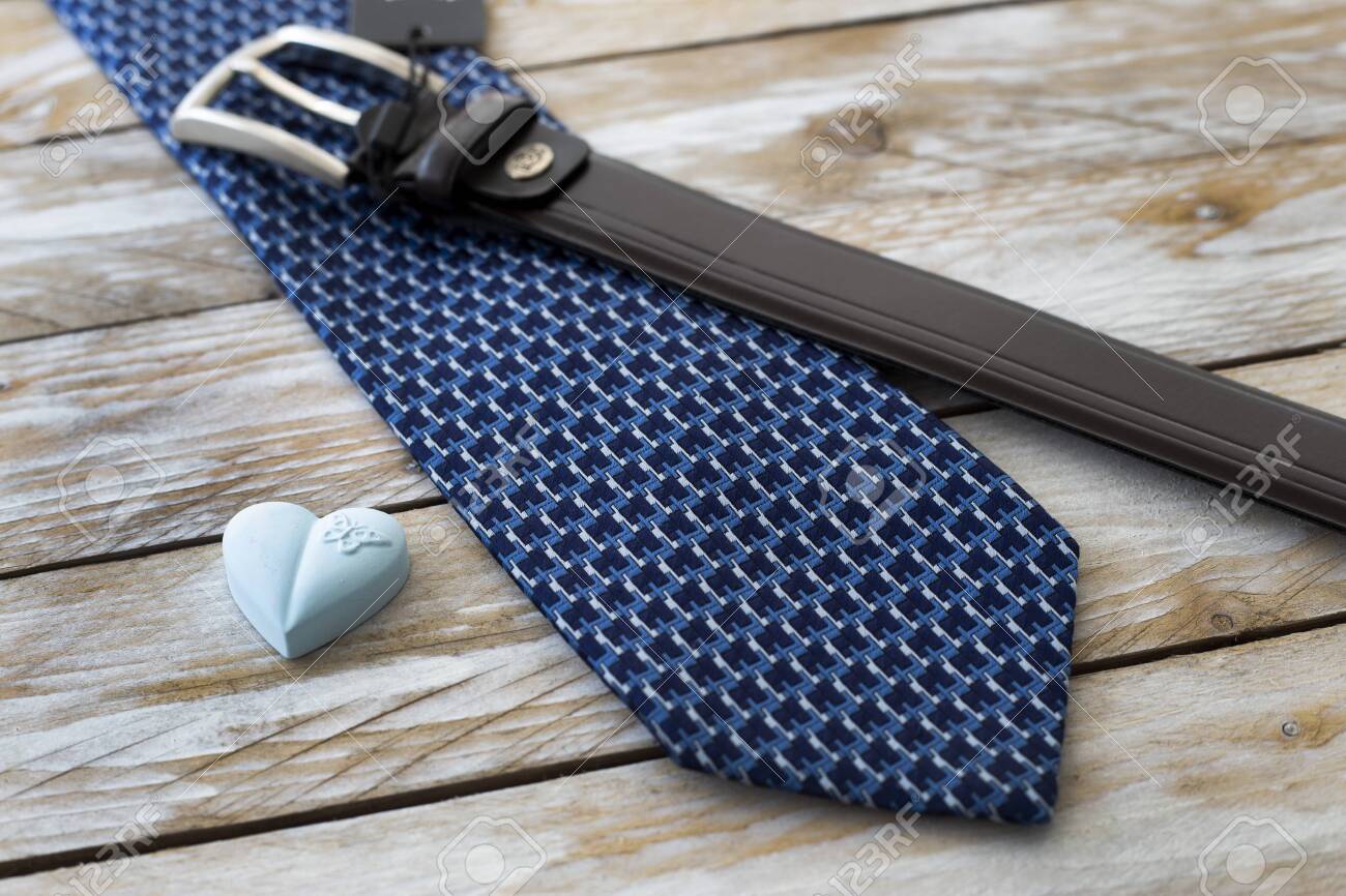 Father's Day Concept. Tie, Belt and heart on wooden background. Copy space for text. - 151220106 Father's Day Concept. Tie, Belt and heart on wooden background. Copy space for text. - 151220106