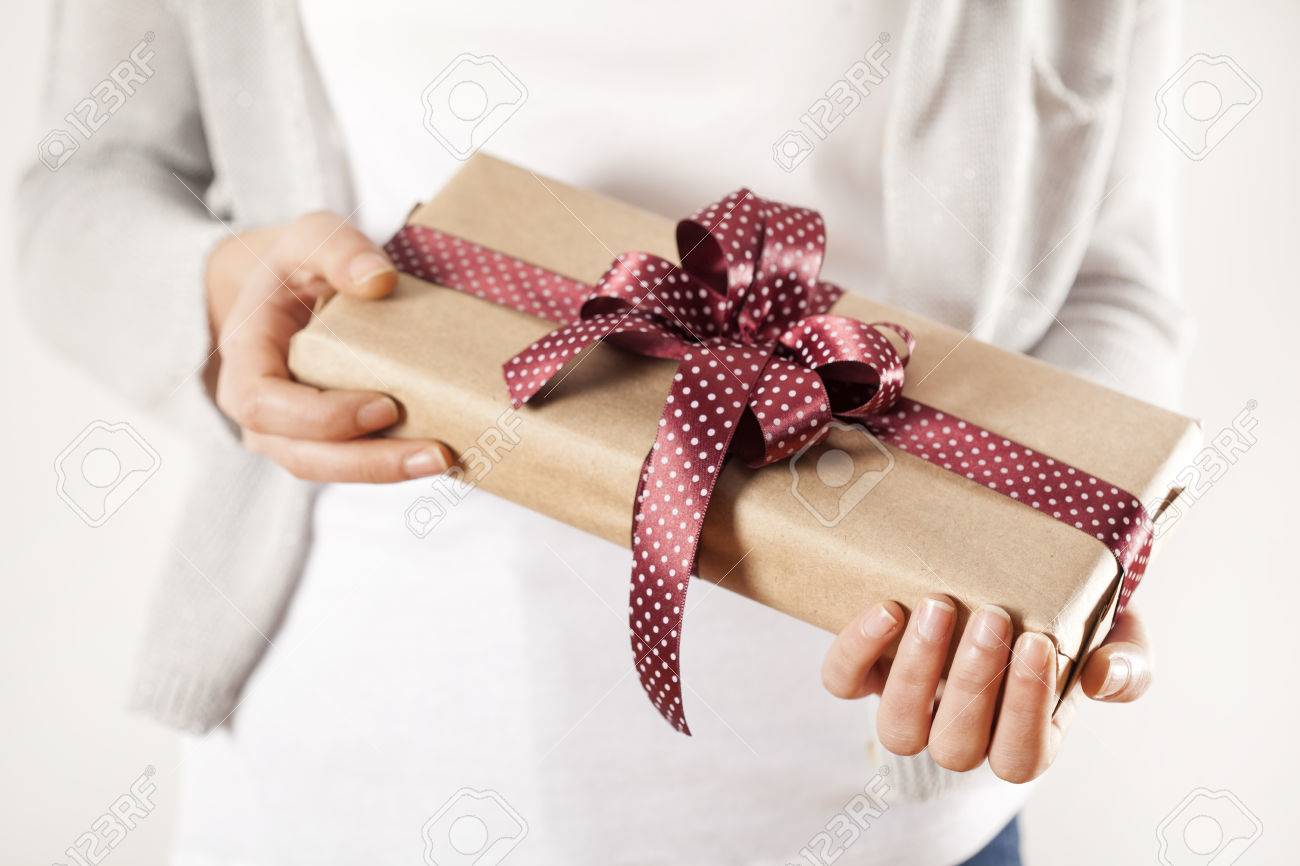 Woman hands holding gift box - 69868636 Woman hands holding gift box - 69868636
