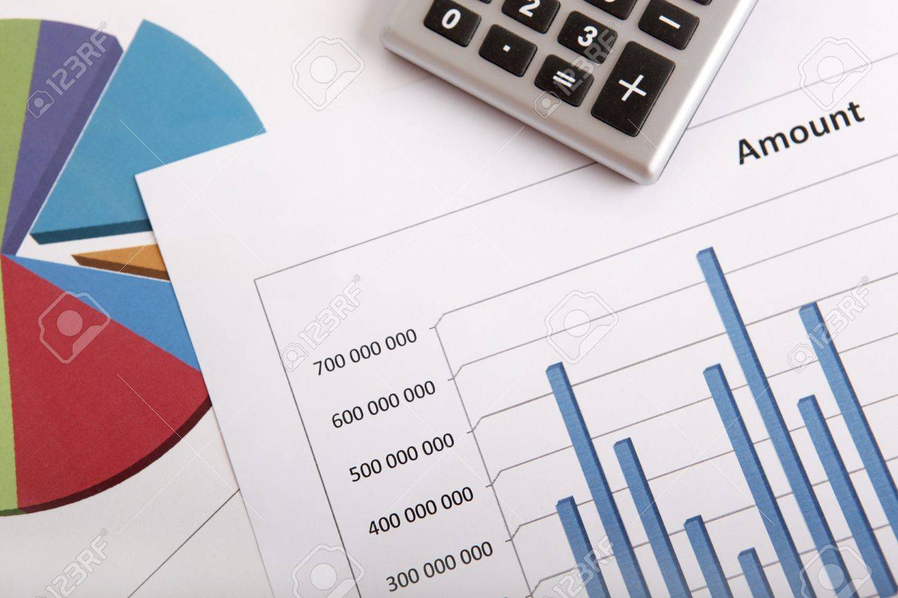A business strategy concept with a calculator and color charts - 20014024 A business strategy concept with a calculator and color charts - 20014024
