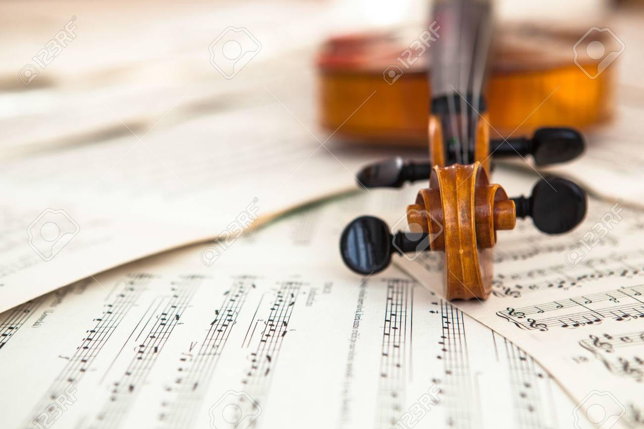 Old violin lying on the sheet of music, music concept - 28873021 Old violin lying on the sheet of music, music concept - 28873021