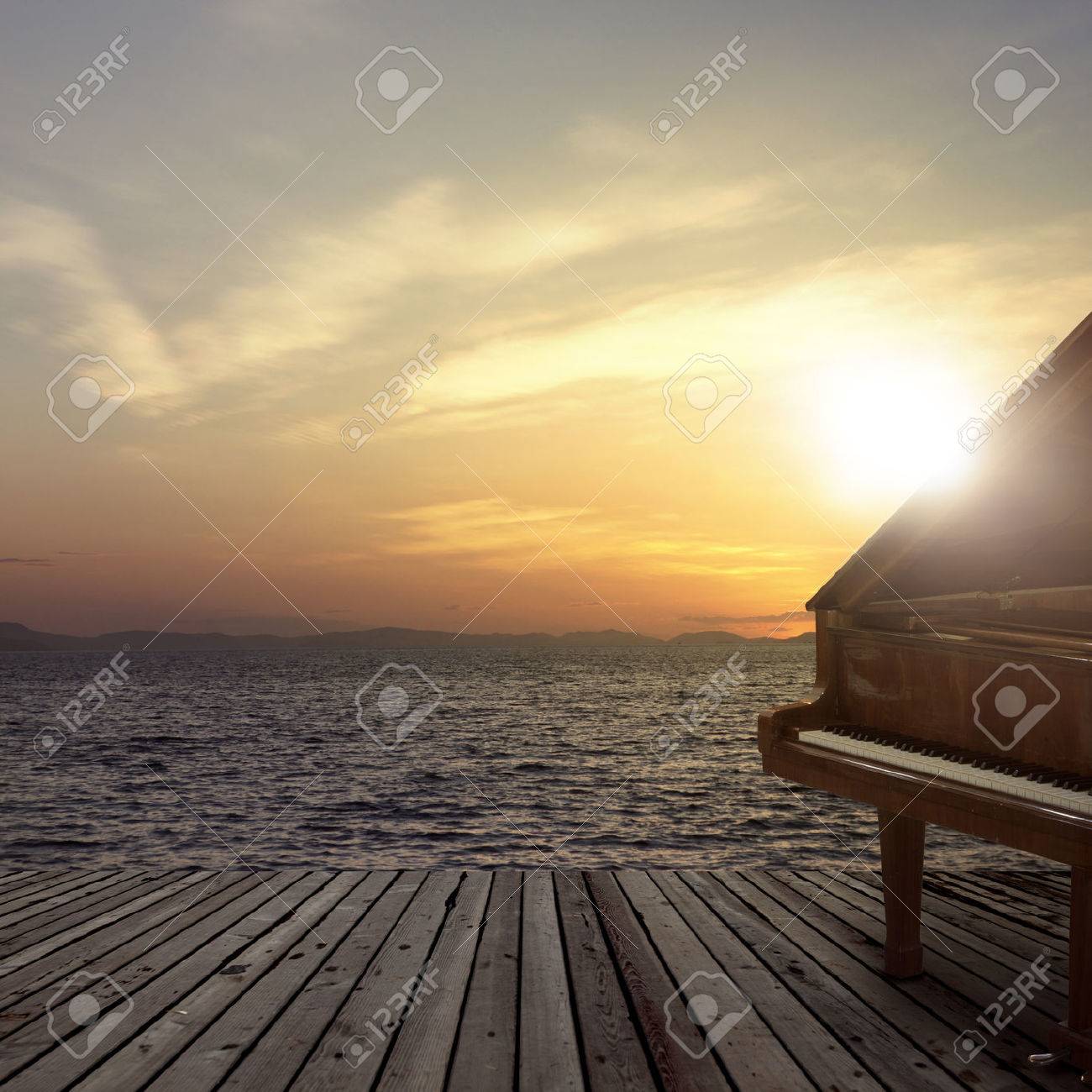 Piano outside shot at sea side during sunset - 63675098 Piano outside shot at sea side during sunset - 63675098
