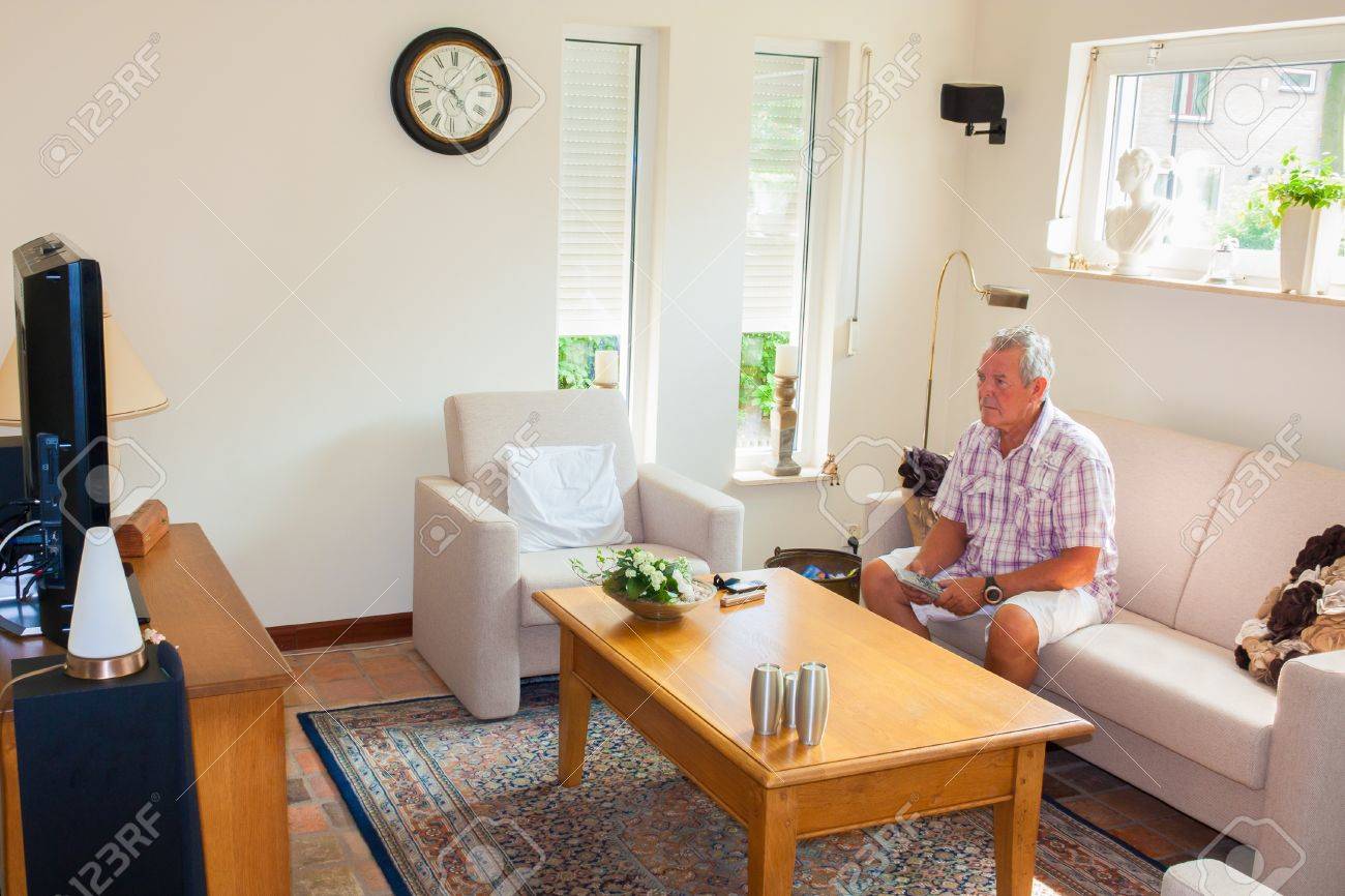 Senior Man Watching TV In Modern Bright Living Room Stock Photo Senior Man Watching TV In Modern Bright Living Room Stock Photo