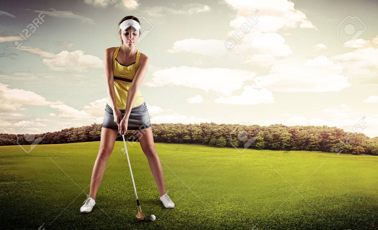 Portrait of female golfer with golf club teeing-off on the nature. Young sporty woman player standing in golf position ready for hit. - 39873247 Portrait of female golfer with golf club teeing-off on the nature. Young sporty woman player standing in golf position ready for hit. - 39873247