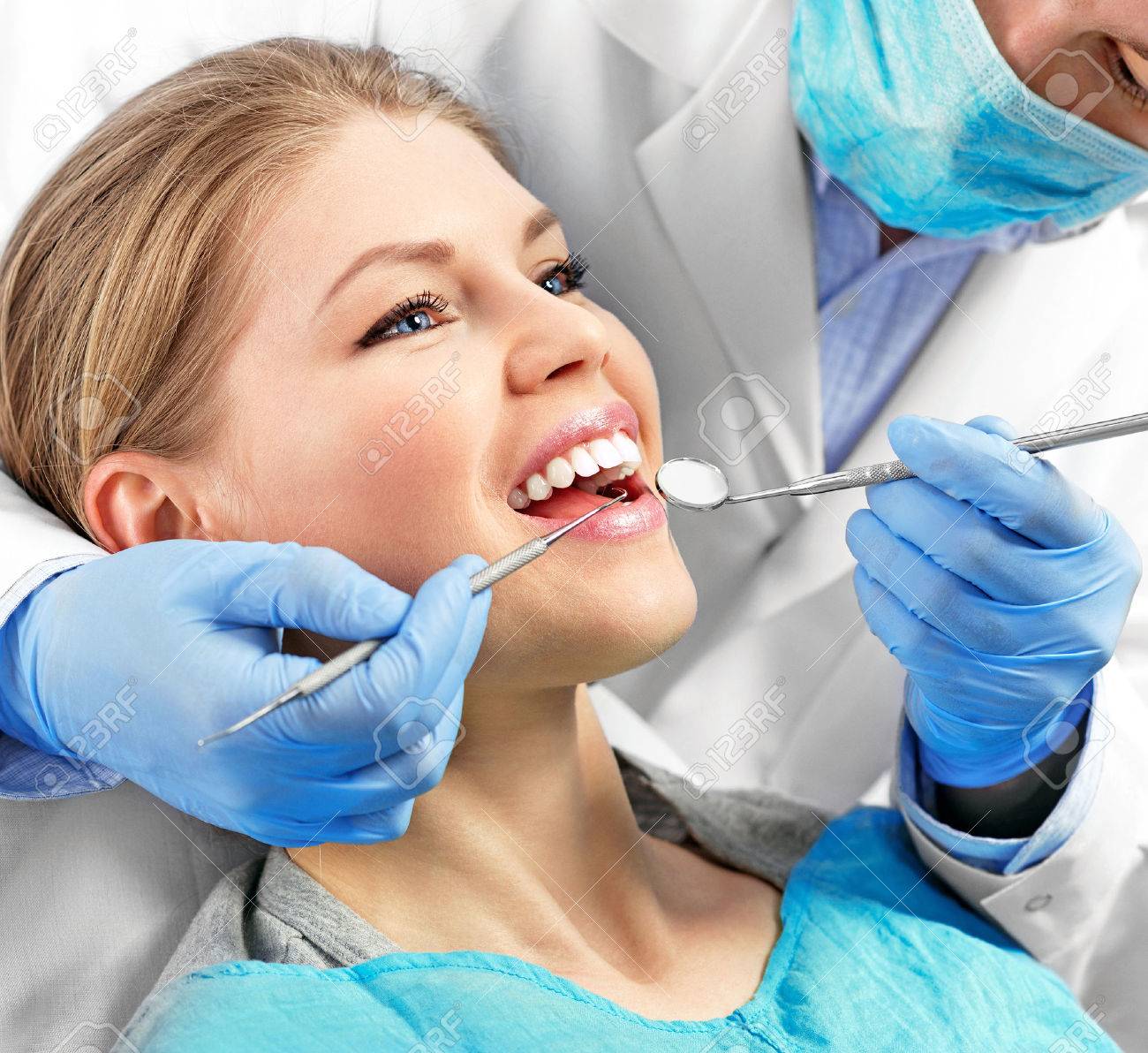 Dental health. Male dentist curing a female patient. - 39370790 Dental health. Male dentist curing a female patient. - 39370790